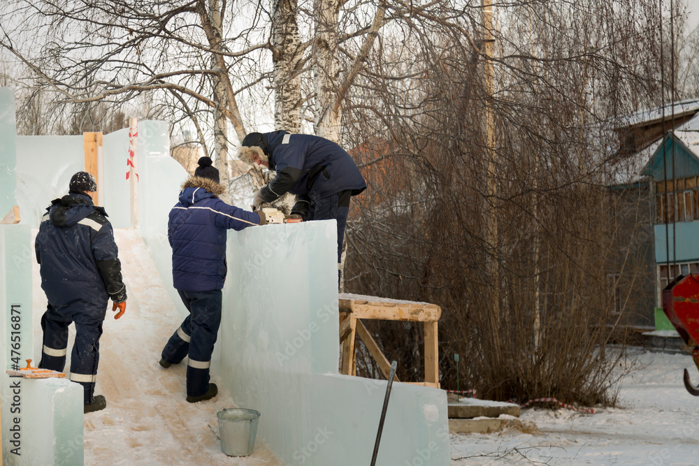 Workers are assembling ice blocks on the frame of a wooden slide Workers are assembling ice blocks on the frame of a wooden slide