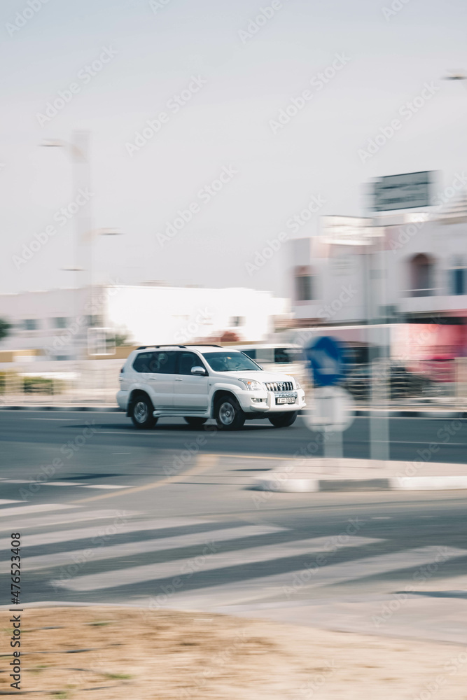 Fast-moving cars and delivery vans with a blurry background in Dubai street Fast-moving cars and delivery vans with a blurry background in Dubai street