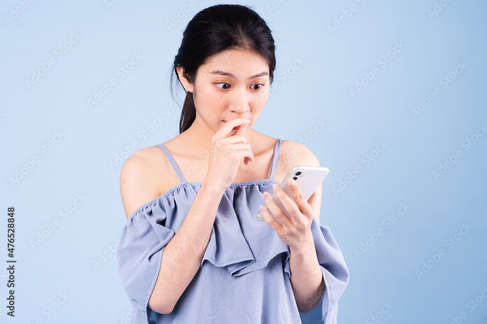 beautiful young asian girl portrait, isolated on blue background beautiful young asian girl portrait, isolated on blue background