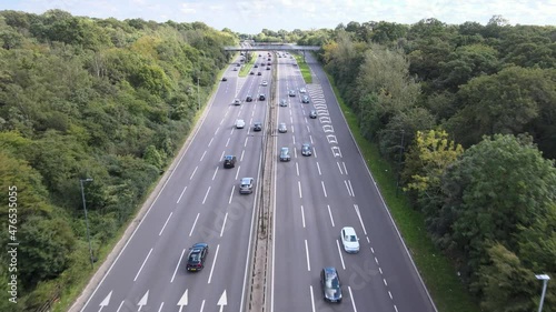Car driving on highway, multilane trunk road surrounded by green vegetation