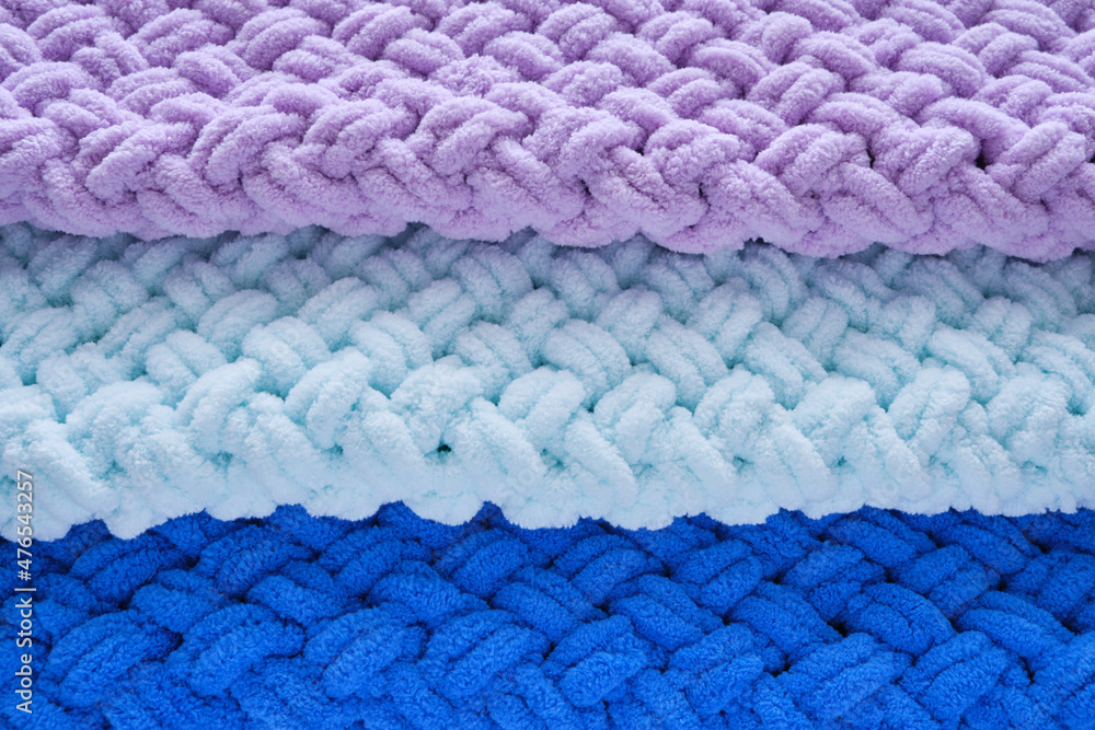 Background, warm, delicate and plush handmade baby blankets in colors of blue, lilac and mint. Background, warm, delicate and plush handmade baby blankets in colors of blue, lilac and mint.
