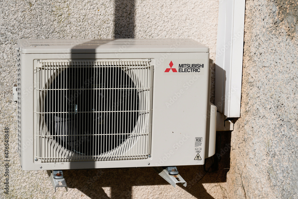 mitsubishi electric air conditioner logo text and brand sign on equipment  conditioning modern outside wall building Stock Photo | Adobe Stock
