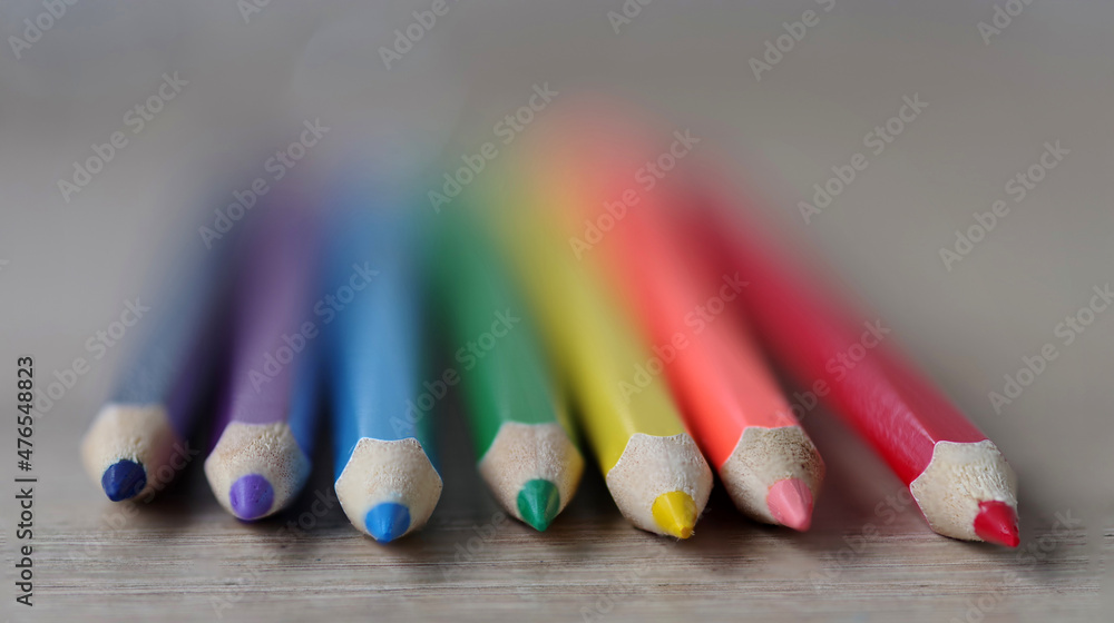 A set of colored pencils lies on the table. Selective focus. . A set of colored pencils lies on the table. Selective focus. .