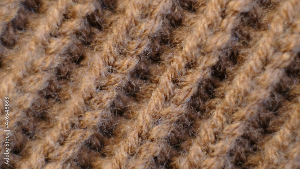 Textile abstract background. Clothing industry concept. Wavy clean material. Fibers of knitted clothes brown white threads. Knitted fabric threads macro