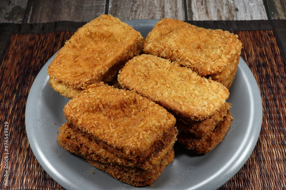 Pile of deep fried crispy fish fillet serving on the plate. Famous appetizer menu in party. Pile of deep fried crispy fish fillet serving on the plate. Famous appetizer menu in party.