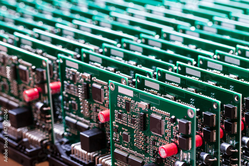 Photos Closeup of Line of Ready Automotive Printed Circuit Boards with Surface Mounted Components