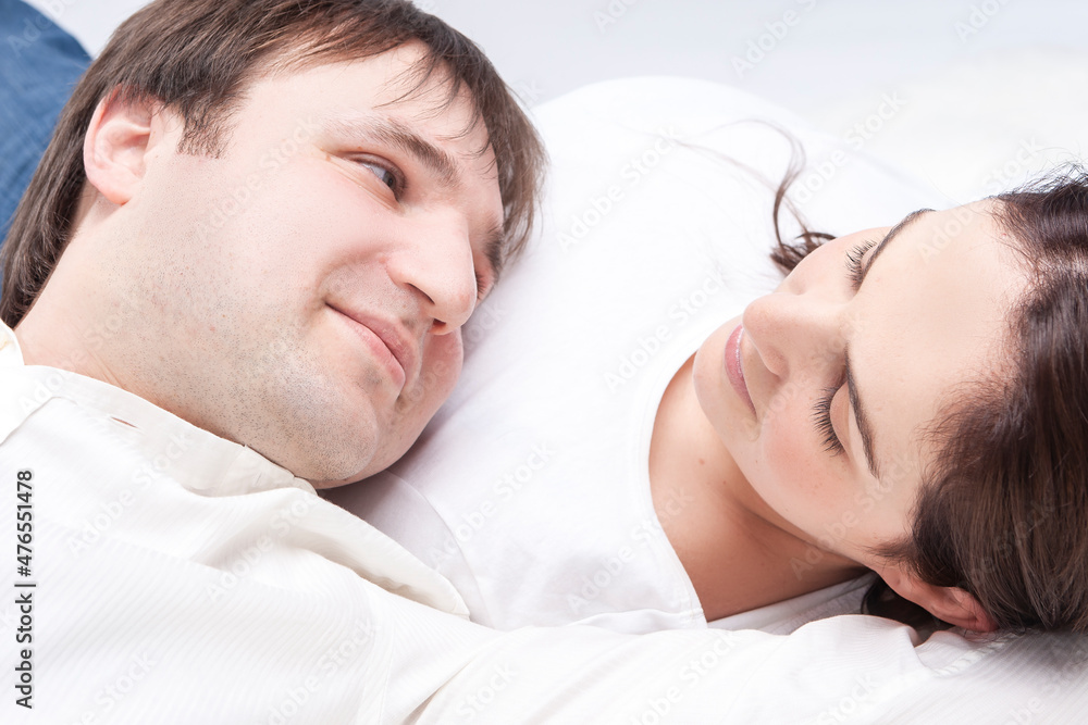 Family Concepts. Caucasian Loving Happy Couple Posing With Heads Turned to Each Other Closely Together Over White Background Family Concepts. Caucasian Loving Happy Couple Posing With Heads Turned to Each Other Closely Together Over White Background
