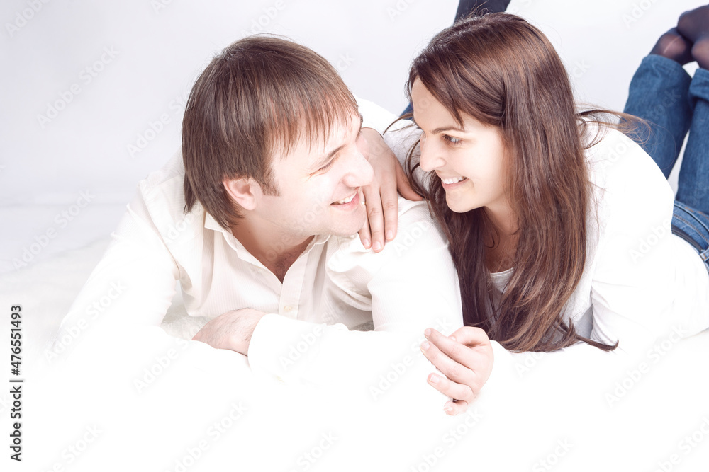 Loving Happy Couple Posing With Heads Turned to Each Other And Connected Hands With Positive Emotions On White Background Loving Happy Couple Posing With Heads Turned to Each Other And Connected Hands With Positive Emotions On White Background