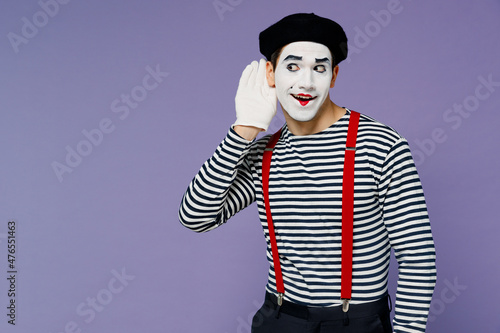 Photos Curious nosy charismatic fun young mime man with white face mask wears striped shirt beret try to hear you overhear listening intently isolated on plain pastel light violet background studio portrait