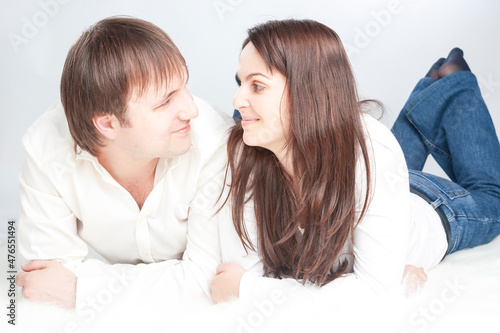 Modern Family Concepts. Caucasian Loving Happy Couple Posing With Heads Turned to Each Other Smiling With Positive Emotions On White Background photo