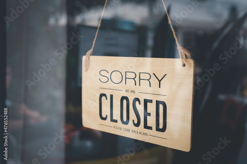 Fotografie, Obraz Blurred picture of a sign hanging behind the shop glass window that says Sorry we are closed