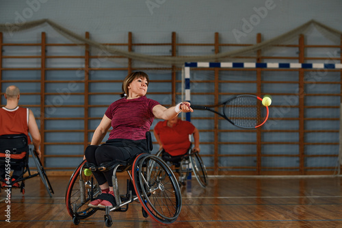 People in wheelchair playing tennis on court. Wheel Chair Tennis For Disabled.