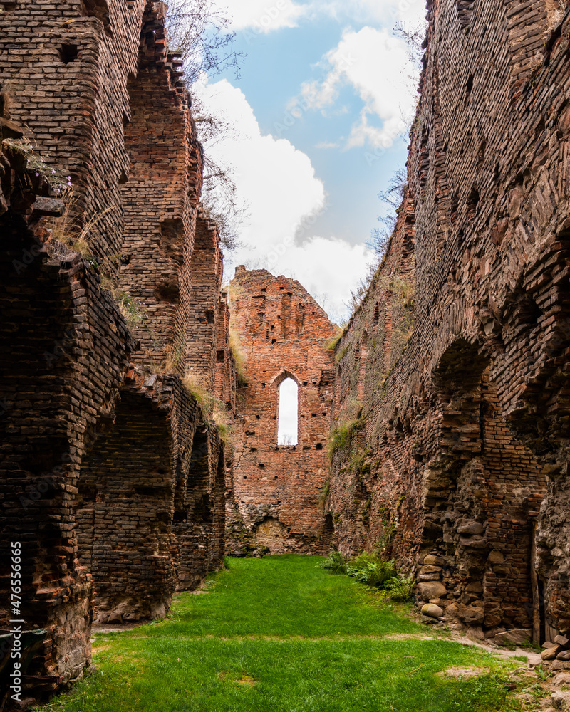 Ruined medieval citadel long hallway with brick walls