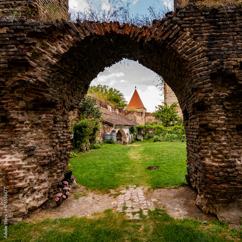 Ruined brick archway inside medieval Slimnic citadel in Romania photo