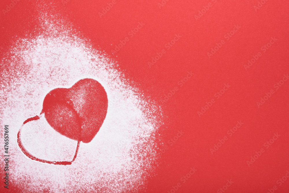 Heart shape frame made of flour on red background. Happy Valentines day, mothers day. Valentines day gift bakery concept for card or creative design. Top view.