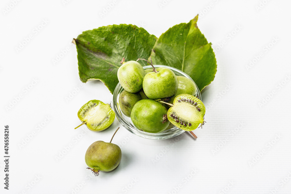 Ripe Actinidia arguta or kiwi isolated on white background Ripe Actinidia arguta or kiwi isolated on white background