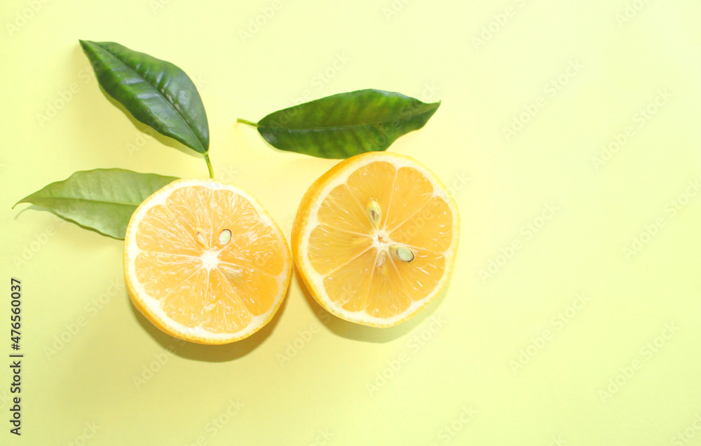 Lemons and leaves on yellow color background Lemons and leaves on yellow color background