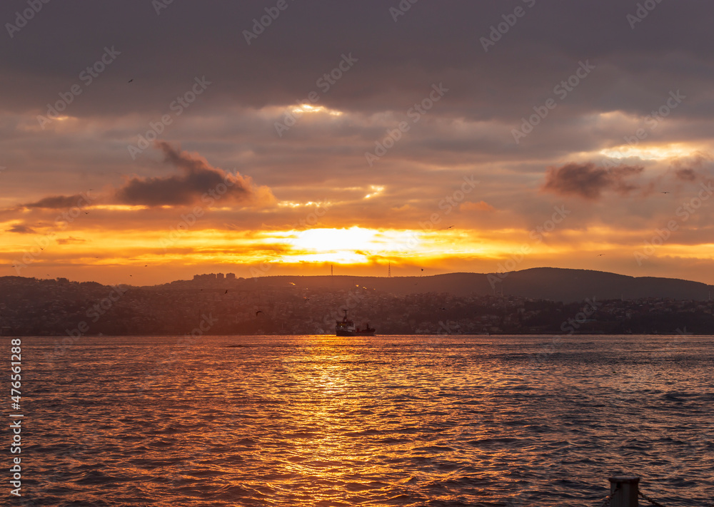 fisherman fishing on Bosporus İstanbul on a Foggy sunrise. Fishing rods on seaside. People jogging on coast. people walking in morning