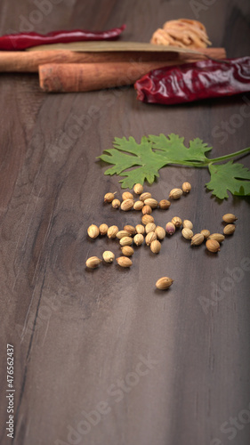 Fototapeta Naklejka Na Ścianę i Meble -  Dry coriander seeds with small bamboo spoon and green fresh bunch coriander leaves,famous spices ingredients in asia's kitchen.