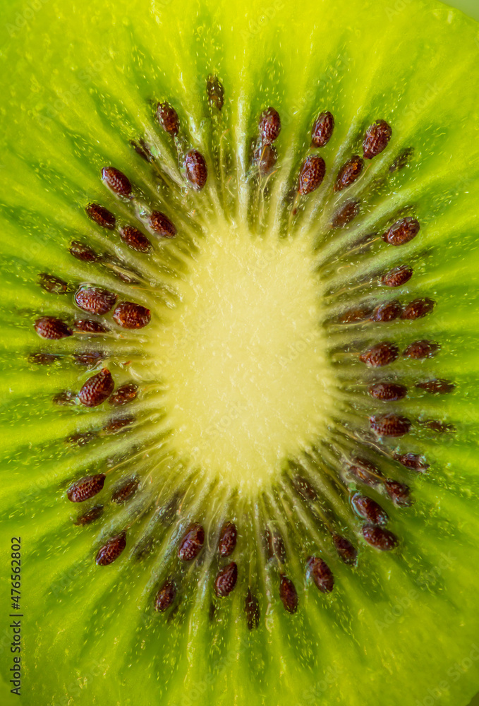 Kiwi closeup as background. Ripe kiwi fruit in the cut. Kiwi seed texture. Kiwi closeup as background. Ripe kiwi fruit in the cut. Kiwi seed texture.