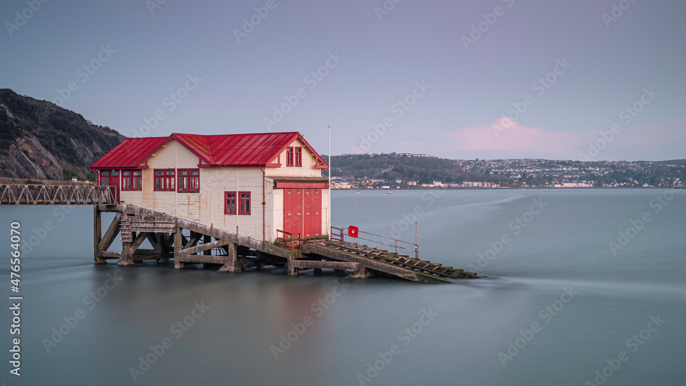 Fototapeta premium Old lifeboat (RNLI) station in Swansea Bay, near the Mumbles, south Wales. 