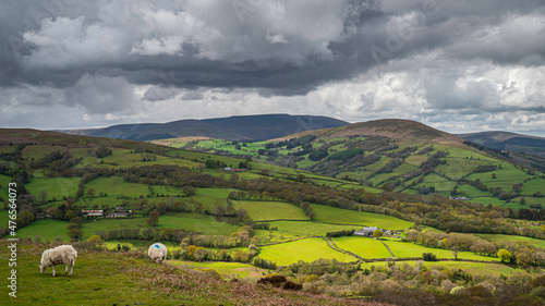 The rolling agricultural hills of mid Wales. The landscape is Talybont, on a cloudy day, with a shaft of sunlight spotlighting a small section of the countryside photo