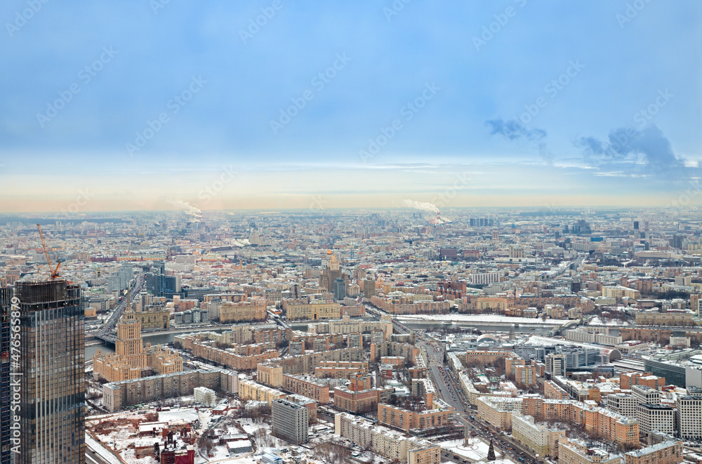 Urban areas and highways are covered with snow, aerial photography