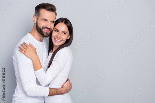 Fotografiet Photo of charming dreamy guy lady dressed white shirts looking empty space huggi
