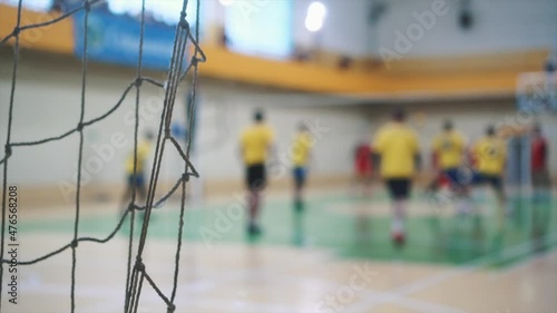 Sport mesh on blurred background of volleyball game, indoor. Competition concept, selective focus.