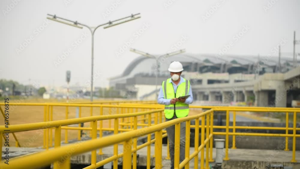 Worker under checking the waste water treatment pond industry large to control water support industry Worker under checking the waste water treatment pond industry large to control water support industry