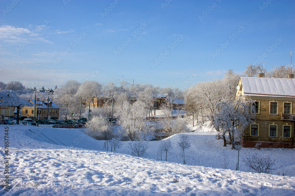 Grodno, Belarus. Winter cityscape: a street in the old part of the city and a small ravine after the first snow.
