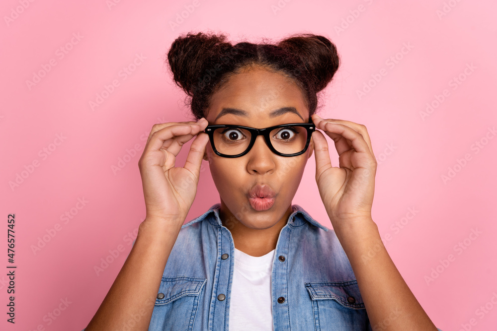 Photo of young african woman pouted lips hands touch eyewear vision eyesight isolated over pink color background Photo of young african woman pouted lips hands touch eyewear vision eyesight isolated over pink color background