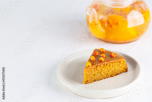 A piece of homemade sea buckthorn pie with orange on a plate. Sugar, gluten and lactose free and vegan. Horizontal orientation, copy space.