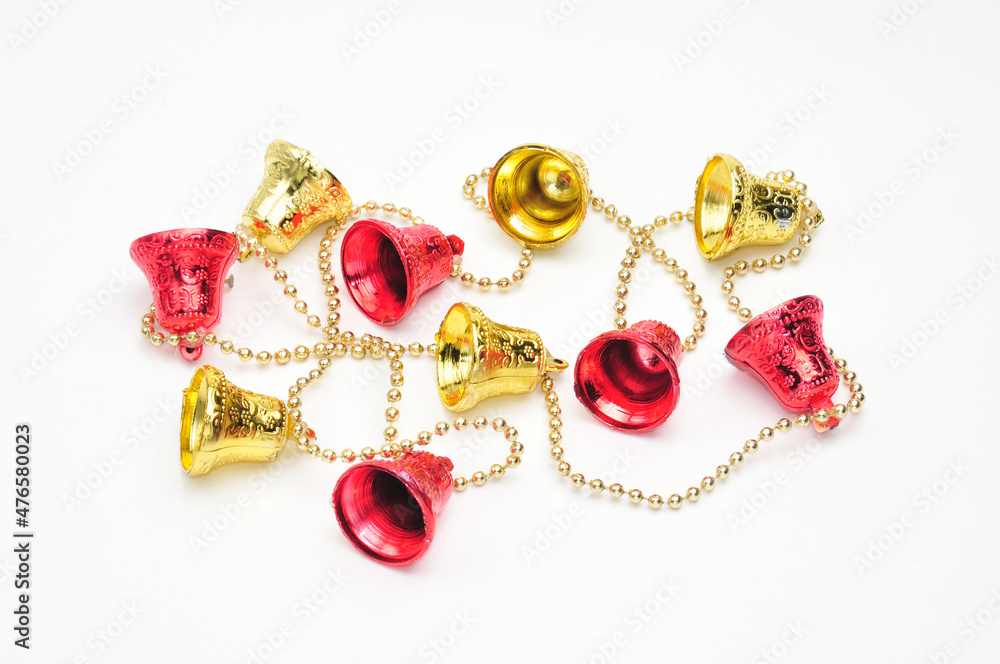 Christmas bells of red and gold color with a chain on a white background Christmas bells of red and gold color with a chain on a white background