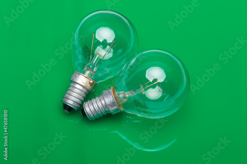 energy-intensive incandescent bulbs on a green background
