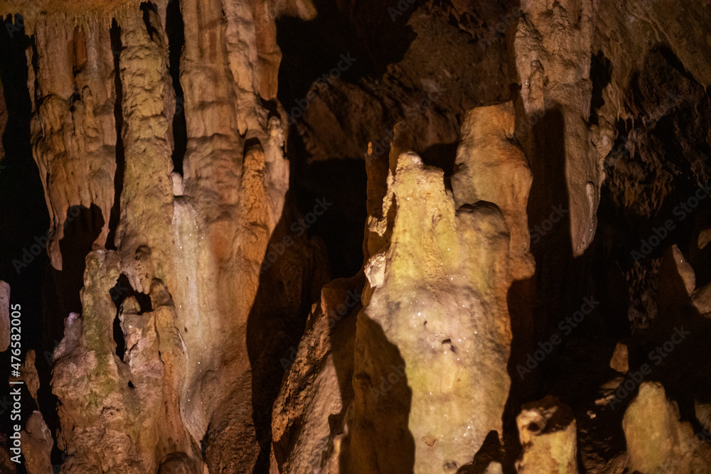 blurred warm abstract background of stalactites, stalagmites and stalagnates in Sfendoni cave, underground, horizontal