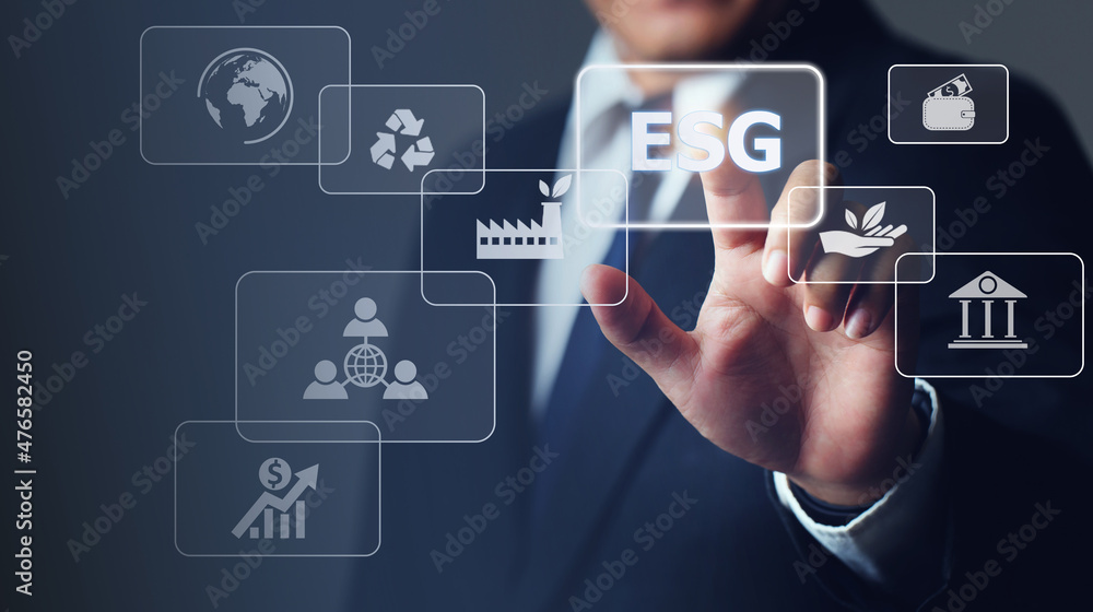 Businessman touching button ESG on-screen with connected virtual icons over the background.ESG environmental social governance business strategy investing concept. Businessman touching button ESG on-screen with connected virtual icons over the background.ESG environmental social governance business strategy investing concept.