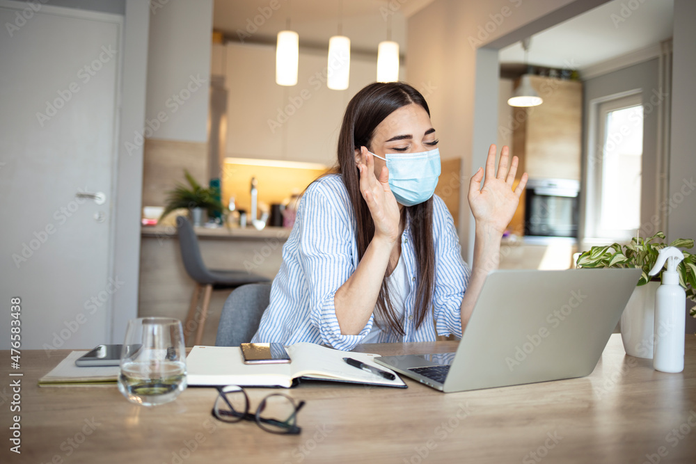 Young woman working on computer with mask Young woman working on computer with mask