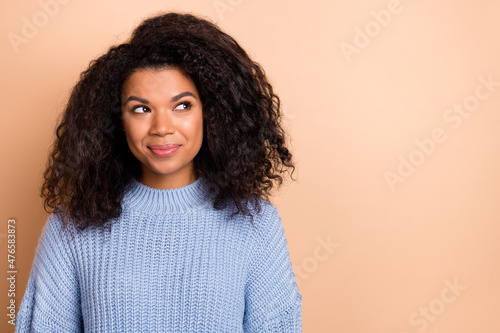 Photo of young adorable lady curious look empty space minded dream isolated over beige color background
