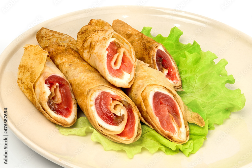 Crispy pancakes with salmon and greens salad on white background Crispy pancakes with salmon and greens salad on white background