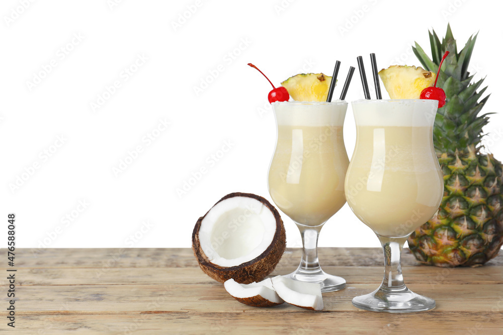 Tasty Pina Colada cocktail and ingredients on wooden table against white background, space for text - obrazy, fototapety, plakaty 