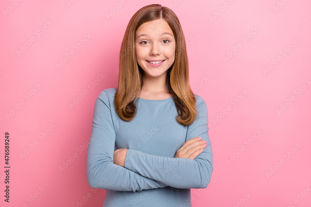 Photo of optimistic blond little girl crossed palms wear blue shirt isolated on pink color background Photo of optimistic blond little girl crossed palms wear blue shirt isolated on pink color background