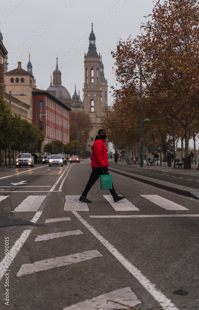 boy crosses a crosswalk on foot