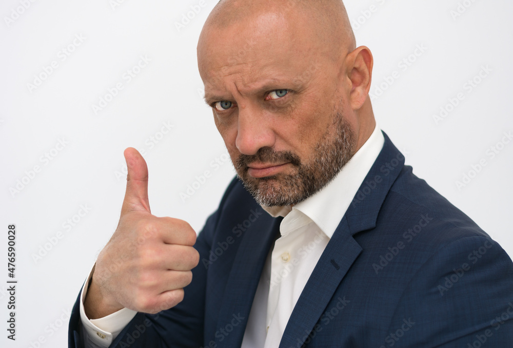 A brutal, bald man shows a hand gesture everything is OK. Elegant man with a beard with a thumbs up gesture. Confident man in a business suit. A brutal, bald man shows a hand gesture everything is OK. Elegant man with a beard with a thumbs up gesture. Confident man in a business suit.