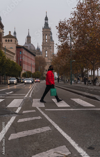 boy crosses a crosswalk on foot