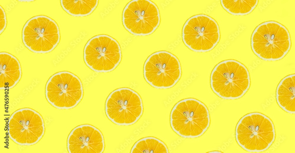 Lemon slices pattern, top view of lemon slices isolated on a yellow background.