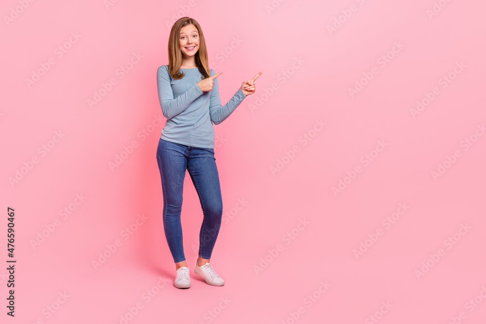 Full length body size view of attractive cheerful girl demonstrating copy space ad isolated over pink pastel color background - obrazy, fototapety, plakaty 
