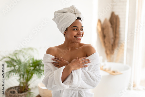 Attractive African American Female Posing Wearing White Bathrobe In Bathroom