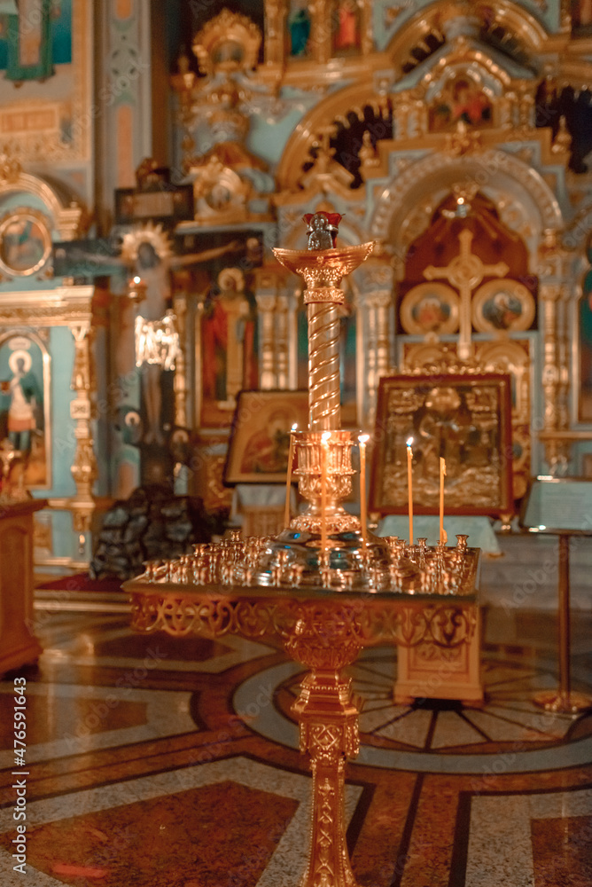 Candles are lit in front of the altar in a Christian church