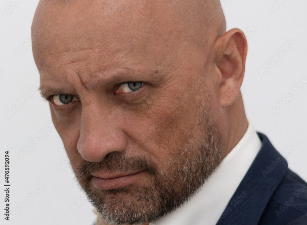 Fototapeta premium Portrait of a bald, brutal man with a beard. Not a shaved European man. Successful businessman in a business suit.